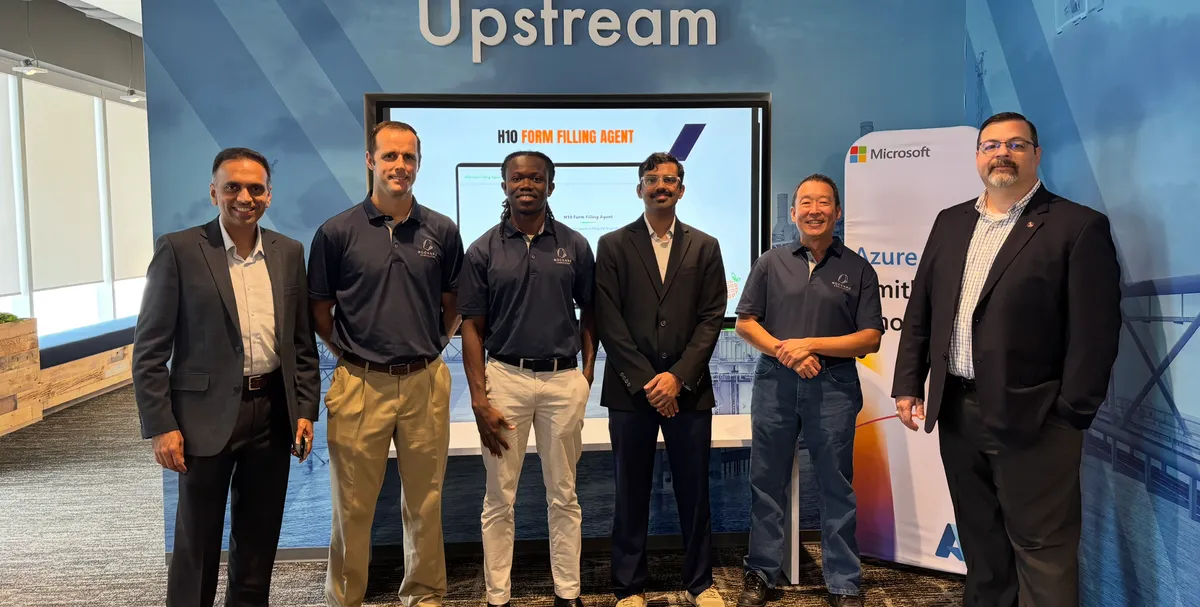 Six people standing in front of an Upstream display and a Microsoft Azure banner